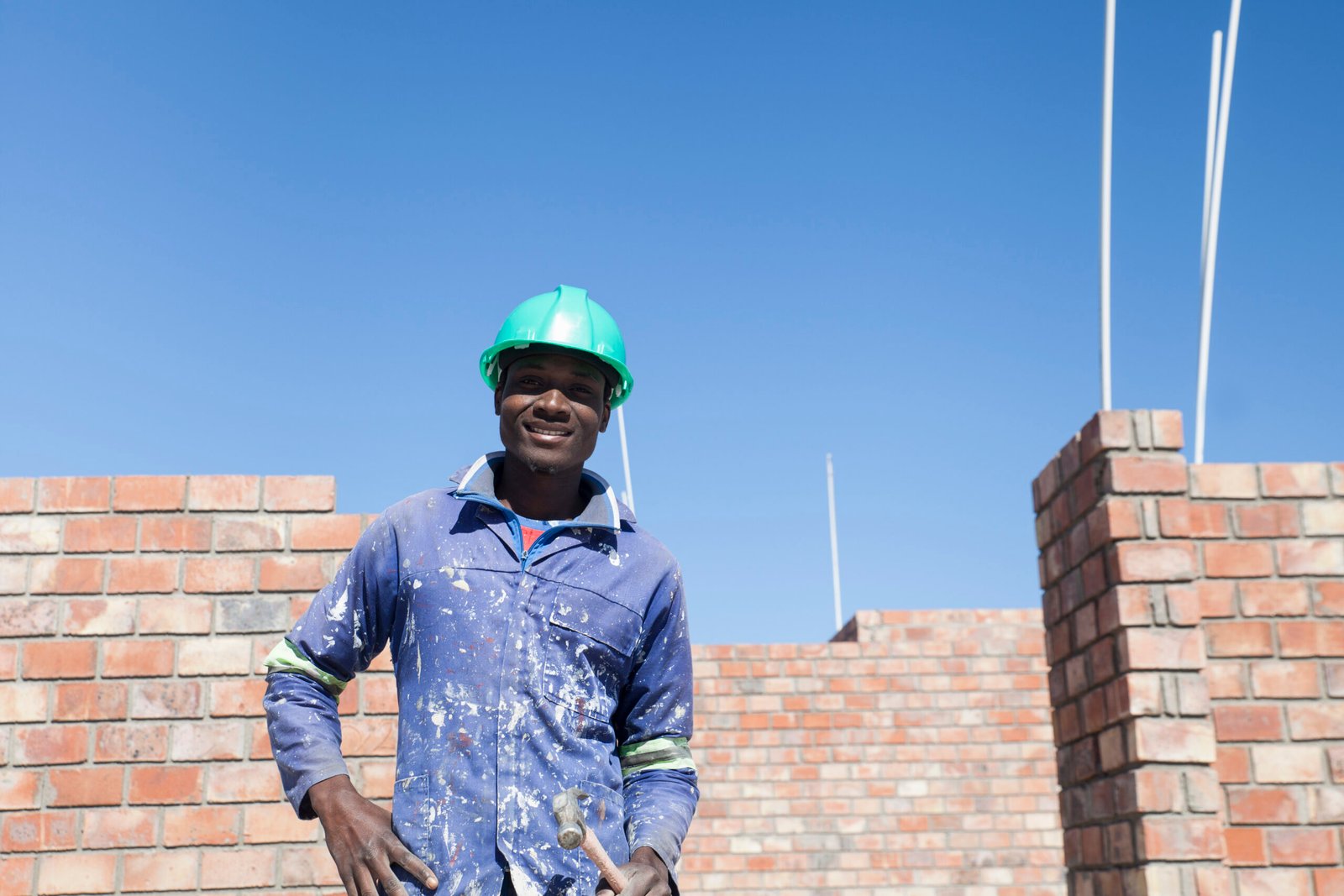 Portrait of builder wearing hard hat looking at camera smiling